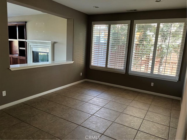 unfurnished room with tile patterned floors