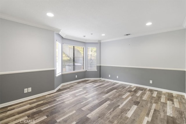 empty room with ornamental molding, recessed lighting, wood finished floors, and baseboards