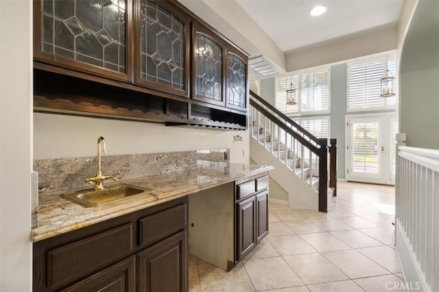 bar featuring stairway, wet bar, light tile patterned flooring, a sink, and recessed lighting