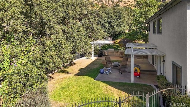 view of yard with fence, a pergola, and a patio