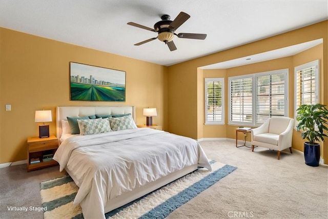 carpeted bedroom featuring ceiling fan and baseboards