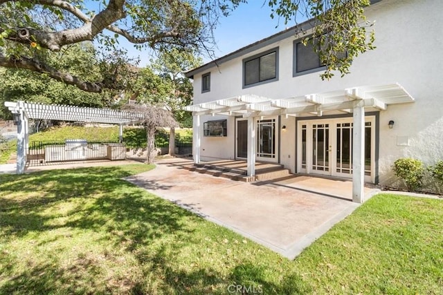 rear view of house featuring stucco siding, a patio area, french doors, and a pergola