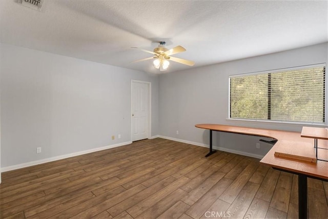 unfurnished office with visible vents, a ceiling fan, a textured ceiling, wood finished floors, and baseboards