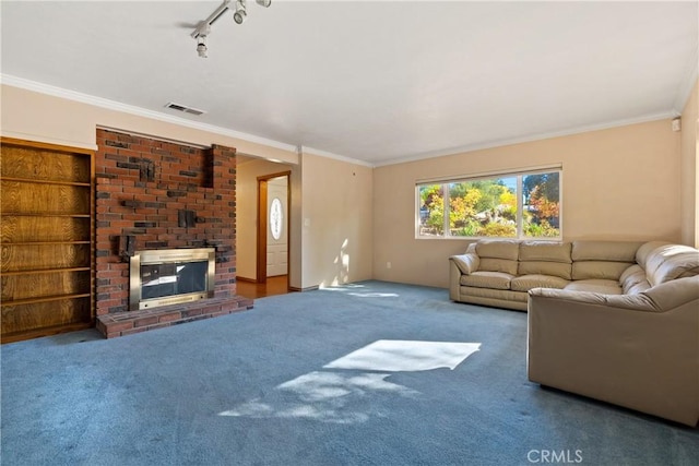 carpeted living room with a fireplace, rail lighting, and ornamental molding