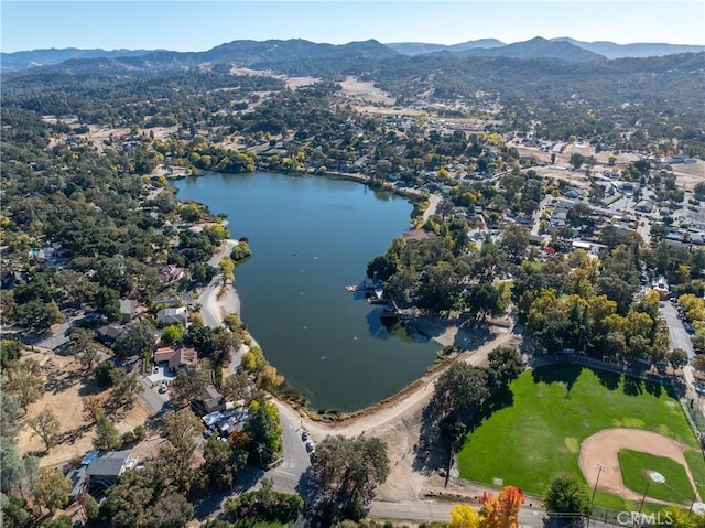 drone / aerial view featuring a water and mountain view