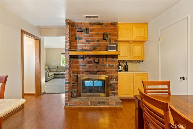 living room with a fireplace and hardwood / wood-style flooring