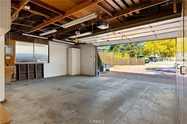 garage with electric panel and a garage door opener