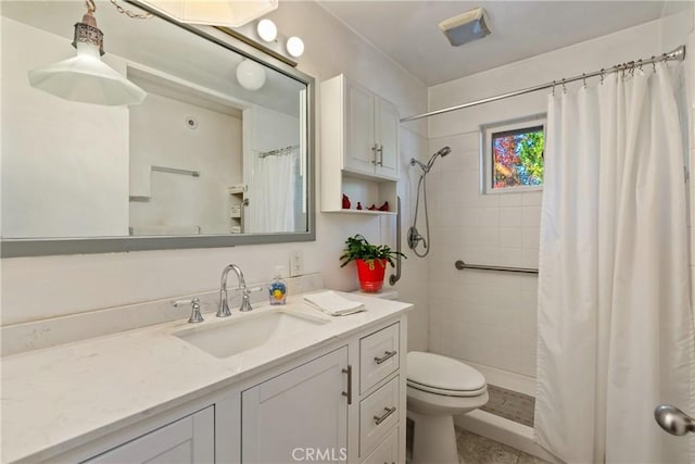 bathroom featuring vanity, a shower with shower curtain, and toilet