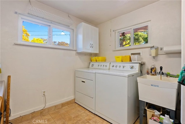 laundry room with cabinets, separate washer and dryer, a healthy amount of sunlight, and sink