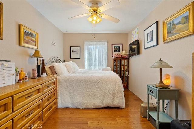 bedroom with ceiling fan and light hardwood / wood-style flooring