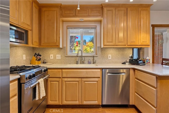 kitchen with decorative backsplash, sink, and stainless steel appliances