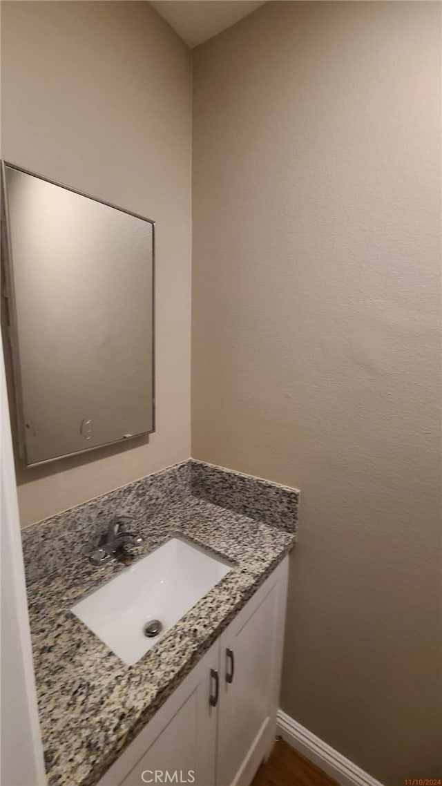 bathroom with vanity and baseboards