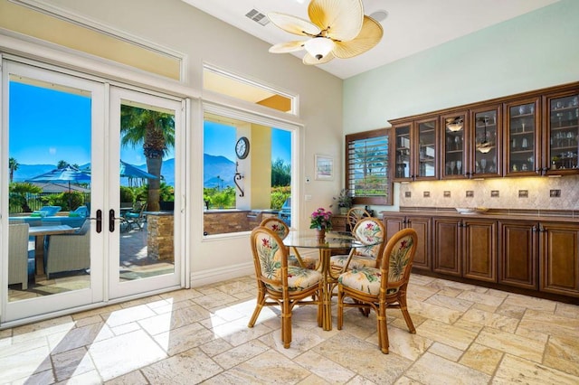 dining area with french doors and ceiling fan