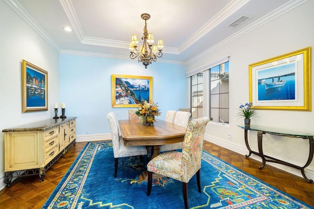 dining space with dark parquet flooring, crown molding, and an inviting chandelier