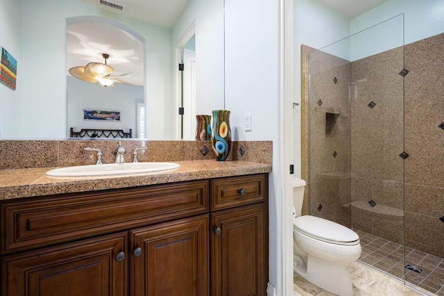 bathroom featuring vanity, toilet, and a shower with door