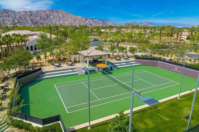 view of tennis court with a mountain view