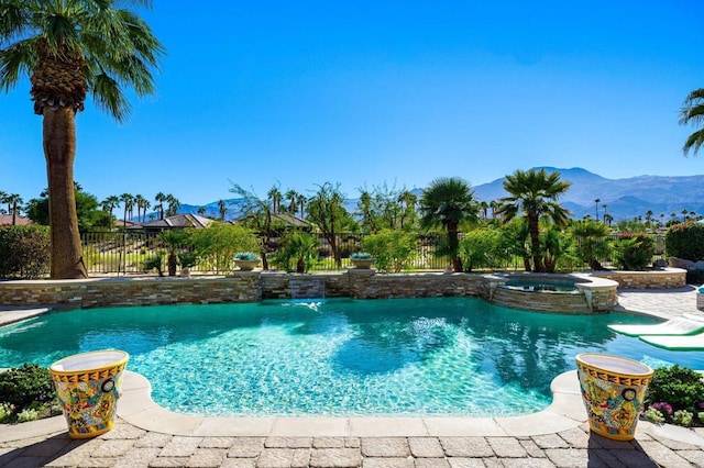 view of swimming pool featuring a mountain view and an in ground hot tub