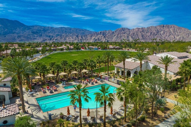 view of swimming pool featuring a mountain view and a patio