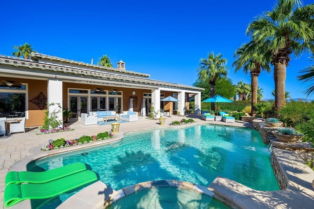 view of pool featuring a patio, ceiling fan, and an in ground hot tub