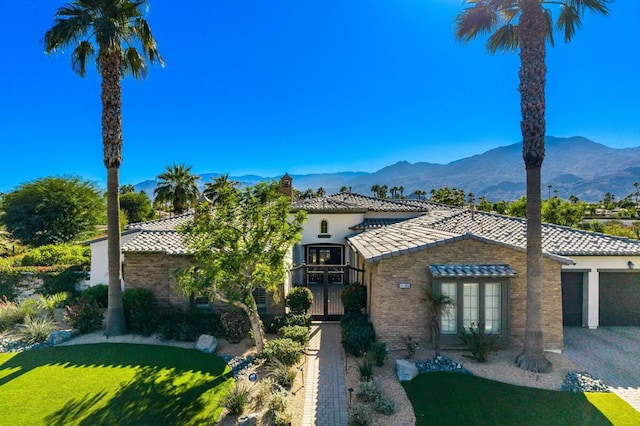 mediterranean / spanish home featuring a garage and a mountain view