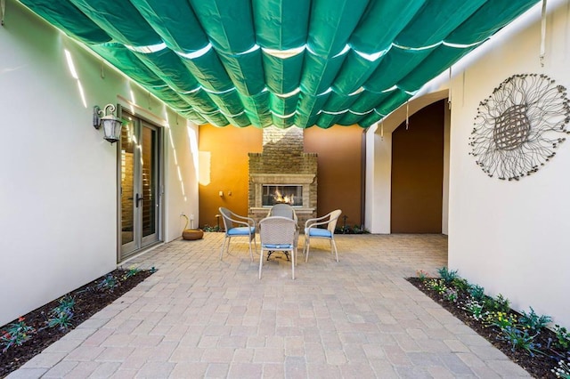 view of patio / terrace featuring an outdoor stone fireplace