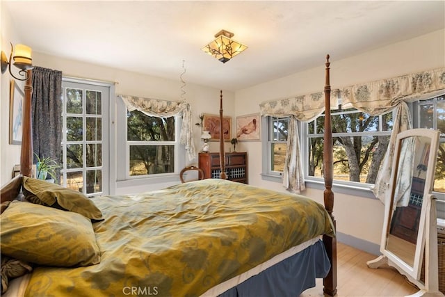 bedroom featuring light hardwood / wood-style flooring and multiple windows