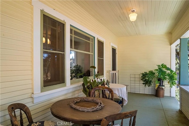 sunroom with a healthy amount of sunlight and wooden ceiling