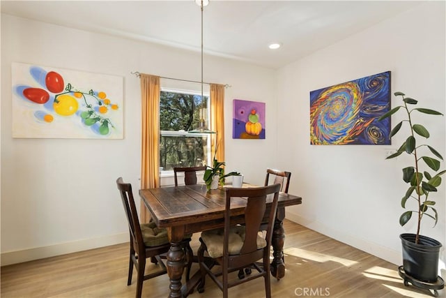 dining area with wood-type flooring