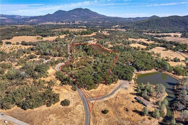 aerial view featuring a water and mountain view