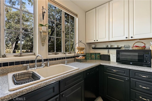 kitchen with white cabinets, plenty of natural light, and black appliances