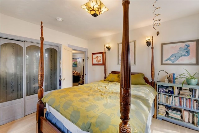 bedroom with light hardwood / wood-style floors and a closet