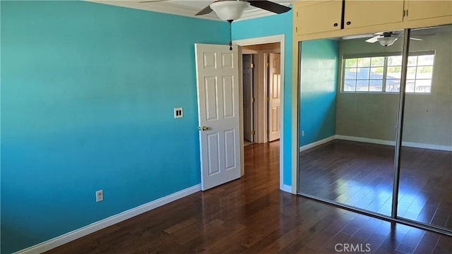 unfurnished bedroom with ceiling fan, dark hardwood / wood-style floors, and a closet