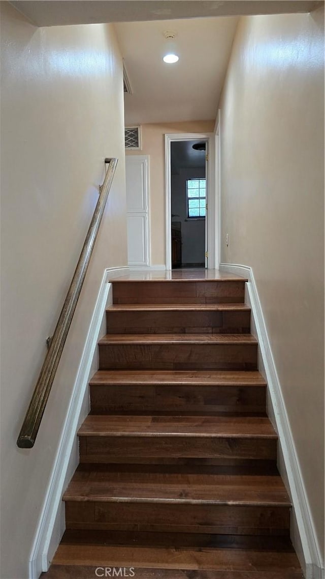 stairs with wood-type flooring