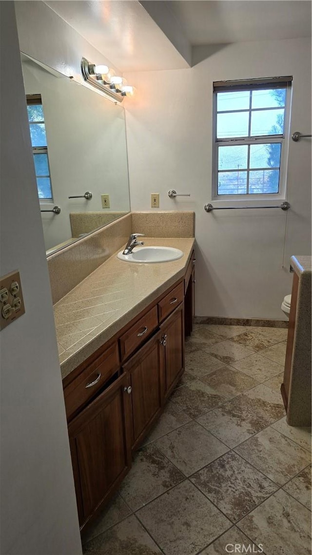 3930 Ironwood St, San Bernardino, CA 92404 - bathroom with vanity, baseboards, and toilet