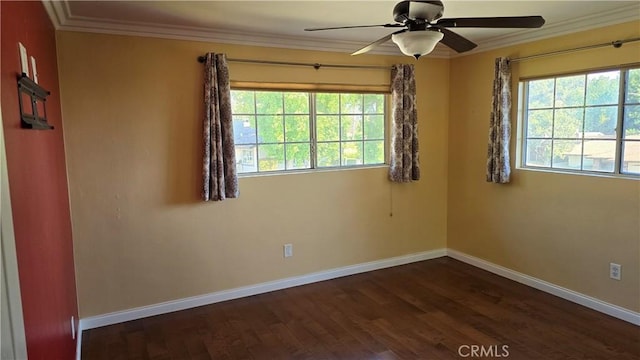 spare room featuring a healthy amount of sunlight, crown molding, and dark wood-type flooring