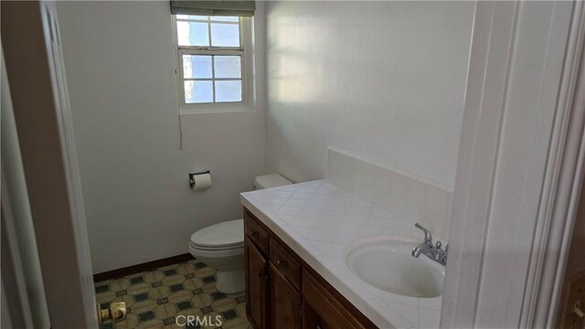 3930 Ironwood St, San Bernardino, CA 92404 - half bathroom with tile patterned floors, vanity, baseboards, and toilet