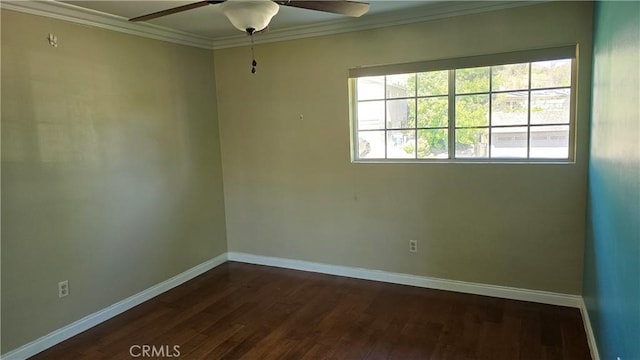 spare room with crown molding, ceiling fan, and dark wood-type flooring