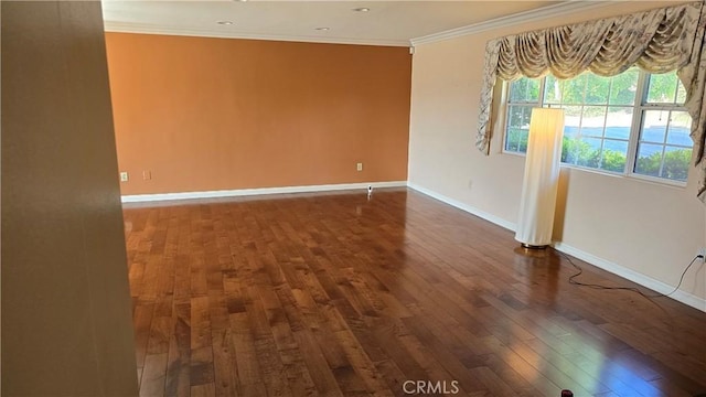 unfurnished room featuring dark hardwood / wood-style floors and ornamental molding