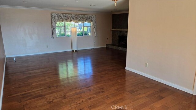 3930 Ironwood St, San Bernardino, CA 92404 - unfurnished living room with crown molding, baseboards, a stone fireplace, and wood finished floors