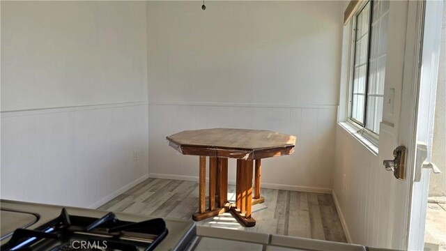 3930 Ironwood St, San Bernardino, CA 92404 - dining space featuring wainscoting and wood finished floors