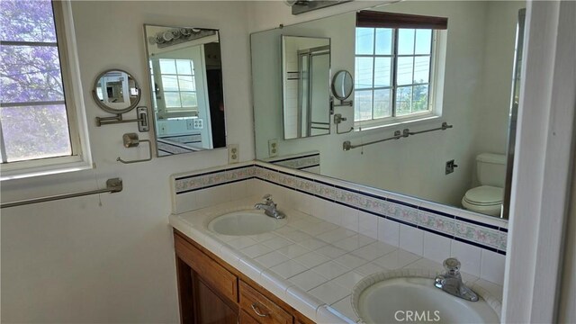 3930 Ironwood St, San Bernardino, CA 92404 - full bath with toilet, double vanity, and a sink
