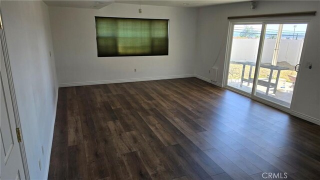 3930 Ironwood St, San Bernardino, CA 92404 - spare room with dark wood-type flooring and baseboards