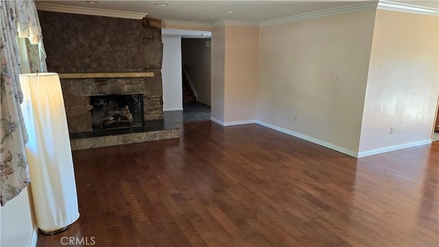 3930 Ironwood St, San Bernardino, CA 92404 - unfurnished living room featuring crown molding, baseboards, a stone fireplace, and hardwood / wood-style flooring