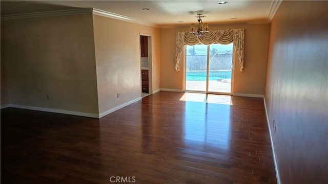 unfurnished room with crown molding, dark hardwood / wood-style flooring, and a notable chandelier