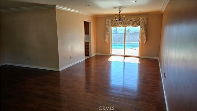3930 Ironwood St, San Bernardino, CA 92404 - unfurnished room with ornamental molding, baseboards, an inviting chandelier, and wood finished floors