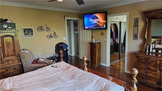 bedroom with ornamental molding, a closet, ceiling fan, and dark wood-type flooring