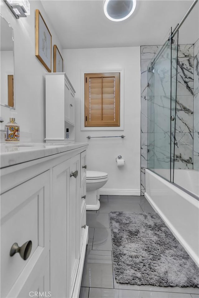 full bathroom with toilet, vanity, baseboards, marble finish floor, and combined bath / shower with glass door