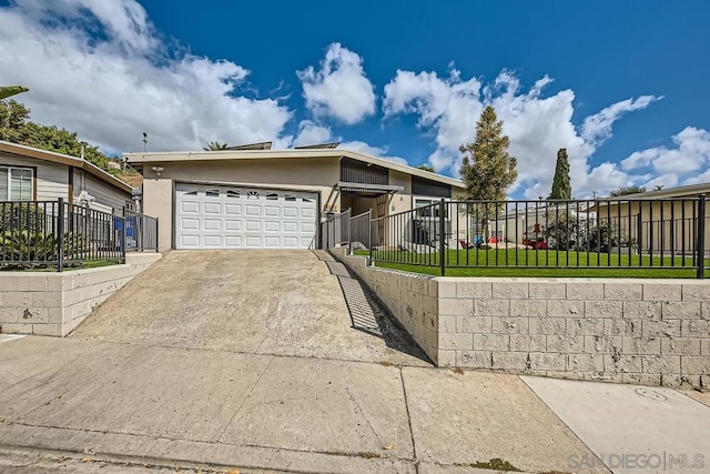 view of front of home with a front yard and a garage