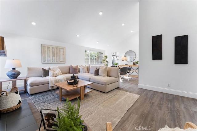 living room featuring hardwood / wood-style floors and vaulted ceiling