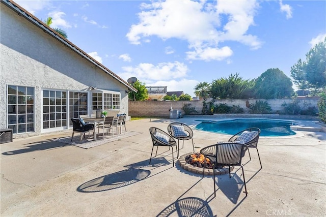 view of pool with an outdoor fire pit and a patio area